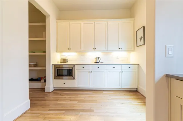 a bath room with a sink and a mirror