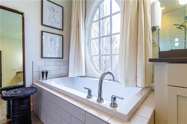 a bathroom with a mirror and a shower