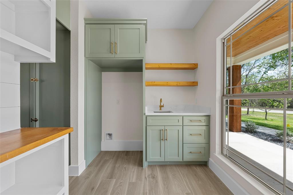 317 North Big Red Way China Spring, TX 76633 - Photo 14 of 40 a room with a sink and a mirror