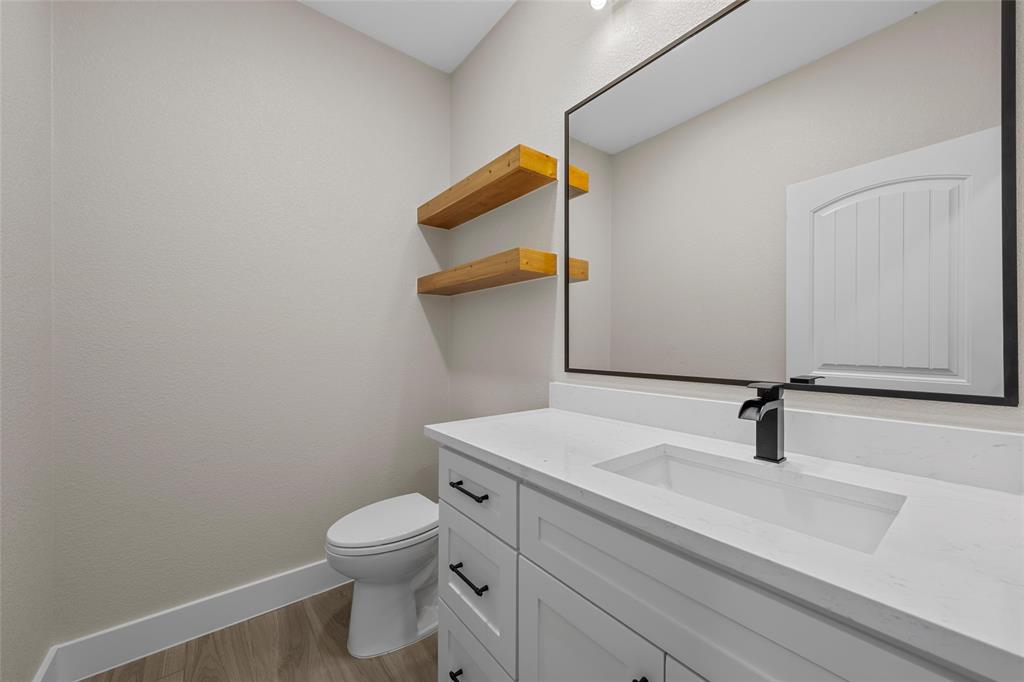 317 North Big Red Way China Spring, TX 76633 - Photo 15 of 40 a bathroom with a sink a toilet and mirror
