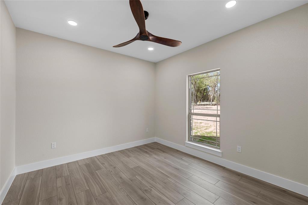 317 North Big Red Way China Spring, TX 76633 - Photo 18 of 40 wooden floor in an empty room with a window