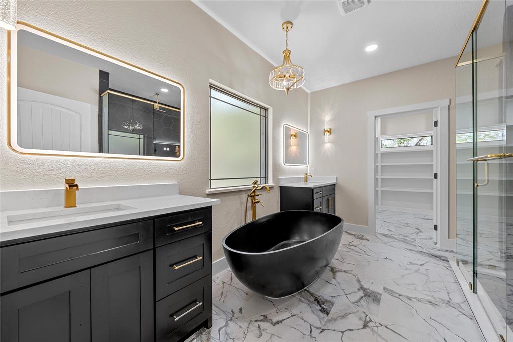 317 North Big Red Way China Spring, TX 76633 - Photo 19 of 40 a spacious bathroom with a granite countertop sink a toilet a mirror and shower