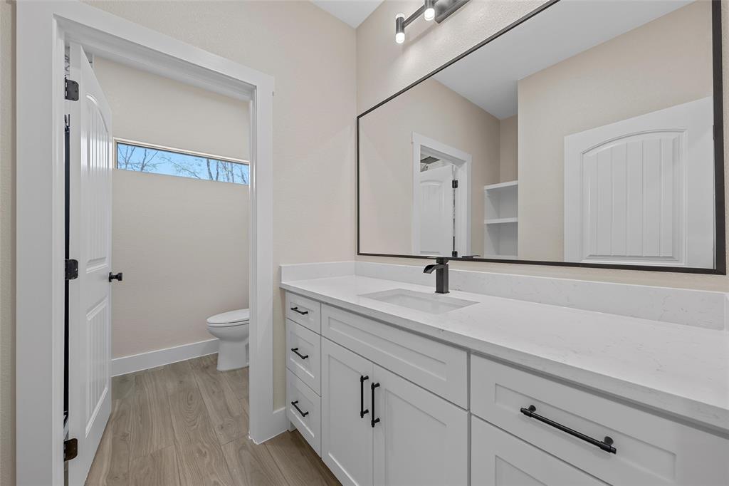 317 North Big Red Way China Spring, TX 76633 - Photo 25 of 40 a bathroom with a sink a toilet and a mirror