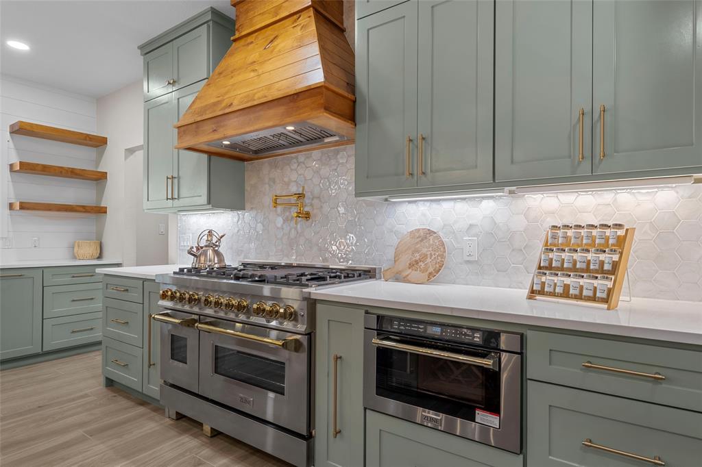 317 North Big Red Way China Spring, TX 76633 - Photo 9 of 40 a kitchen with stainless steel appliances granite countertop a stove and a microwave