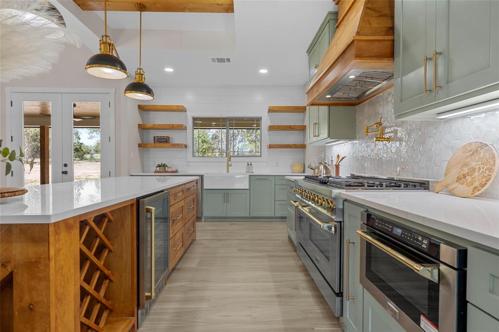 317 North Big Red Way China Spring, TX 76633 - Photo 10 of 40 a kitchen with stainless steel appliances granite countertop a sink and a stove
