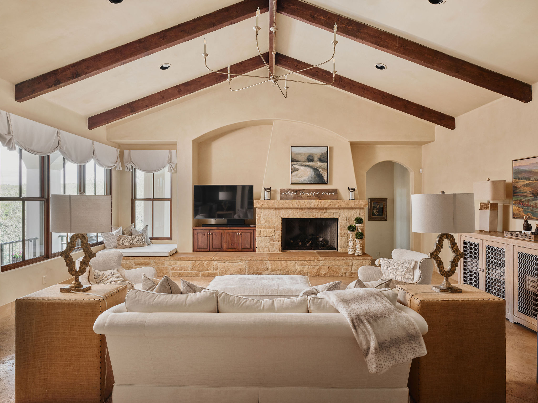433 Brandon Way Austin, TX 78733 - Photo 8 of 40 Exposed beams accentuate the high ceilings in this inviting living space, centered around a natural stone fireplace.