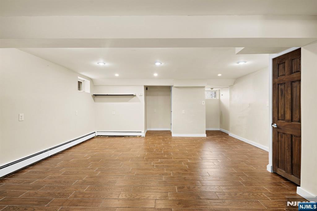 665 9th Street, Unit B Secaucus, NJ 07094 - Photo 12 of 17 a view of an empty room with wooden floor