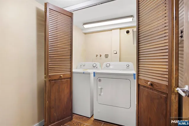a utility room with cabinets washer and dryer