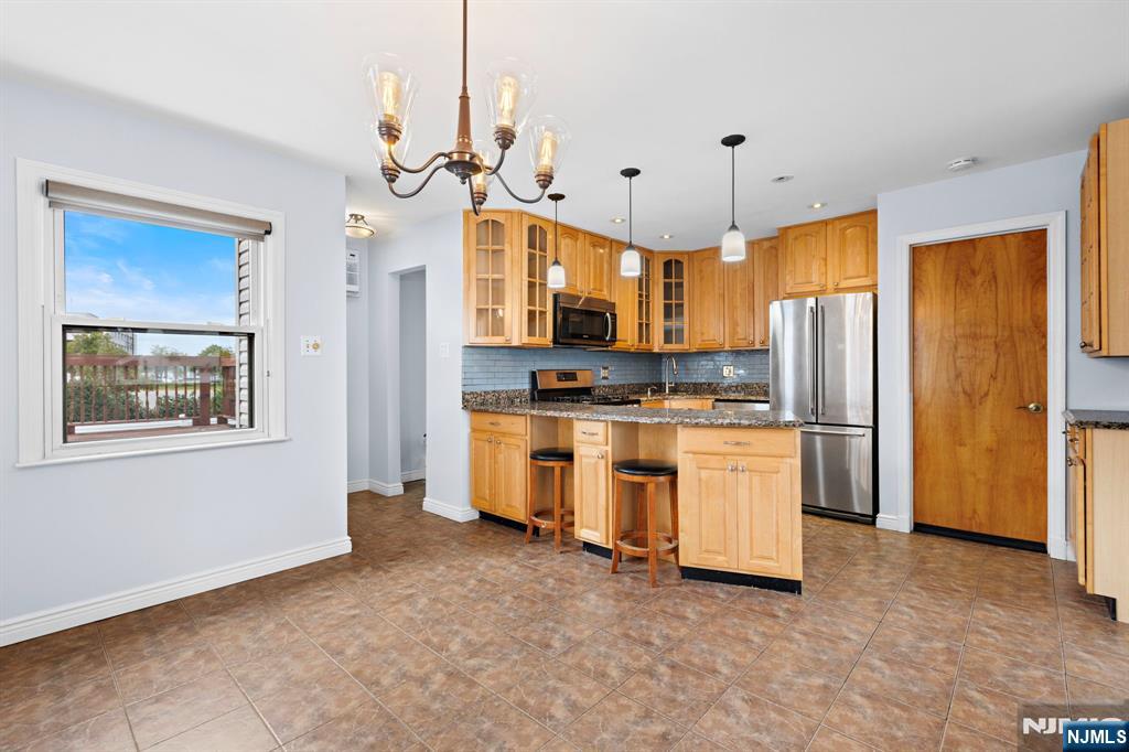 665 9th Street, Unit B Secaucus, NJ 07094 - Photo 4 of 17 a kitchen with white cabinets and refrigerator