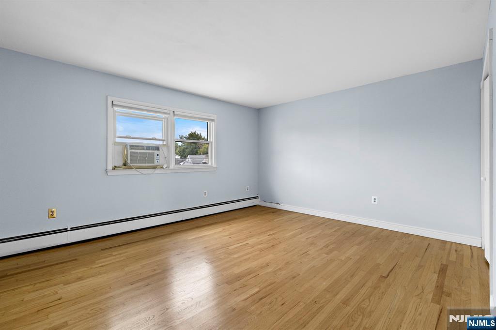 665 9th Street, Unit B Secaucus, NJ 07094 - Photo 9 of 17 an empty room with wooden floor and windows