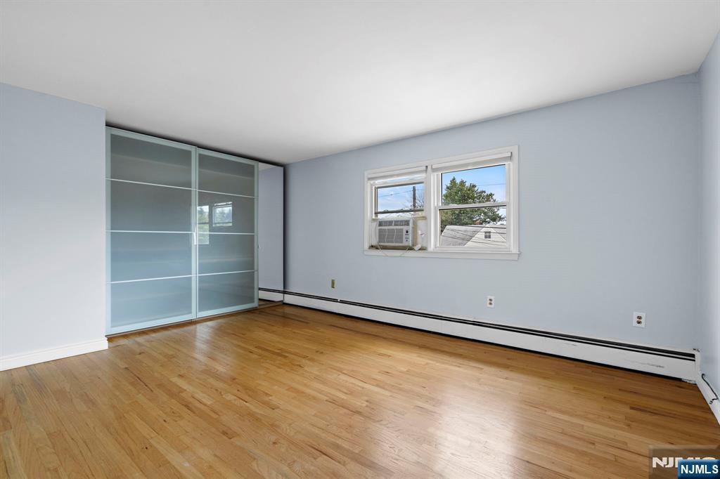 665 9th Street, Unit B Secaucus, NJ 07094 - Photo 10 of 17 an empty room with wooden floor and windows