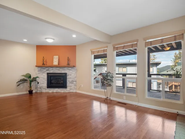 a kitchen with stainless steel appliances granite countertop wooden floor dining table and chairs