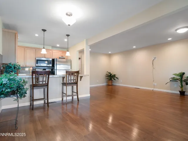 an empty room with wooden floor and a fireplace