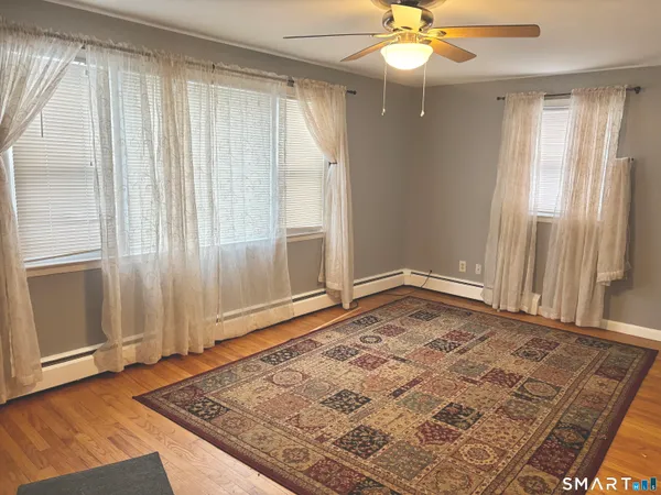 wooden floor in an empty room with a window