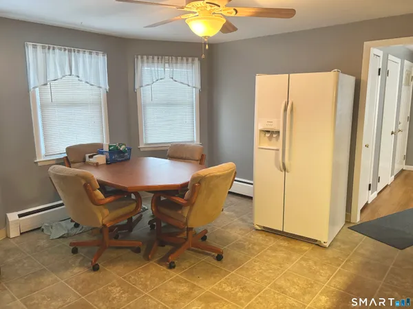a dining room with furniture and window