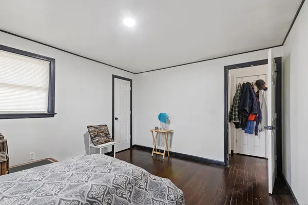 a bedroom with furniture and wooden floor