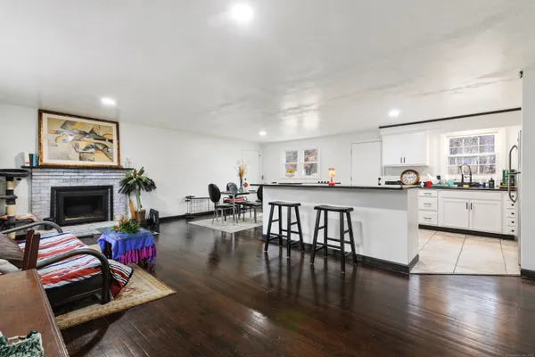 a living room with furniture and kitchen view