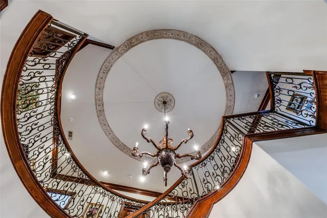 wooden floor view with a fireplace and a chandelier