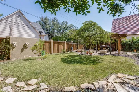 a backyard of a house with table and chairs