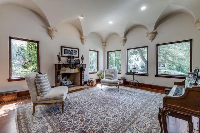 a living room with fireplace furniture and a large window
