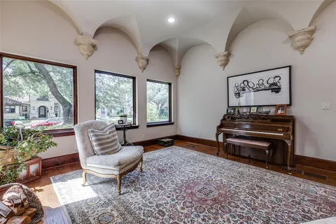 a living room with furniture a piano and a fireplace
