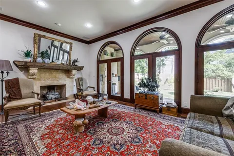 a living room with furniture fireplace and large windows