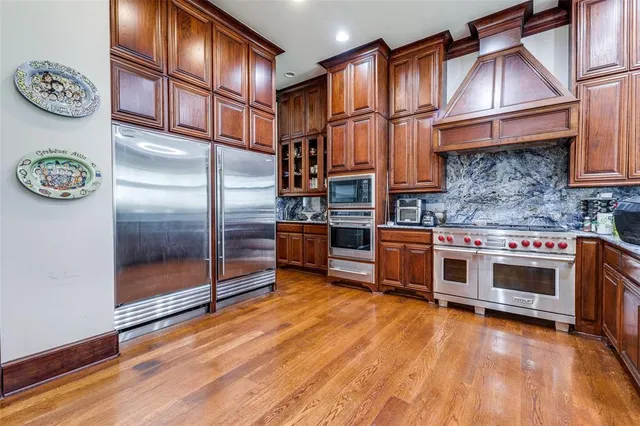 a kitchen with stainless steel appliances granite countertop a stove and a refrigerator