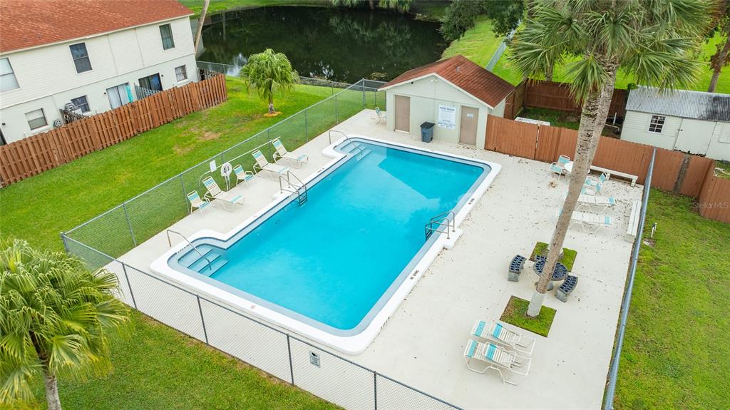 980 Canal View Boulevard, Unit J4 Port Orange, FL 32129 - Photo 19 of 25 swimming pool with outdoor seating and yard