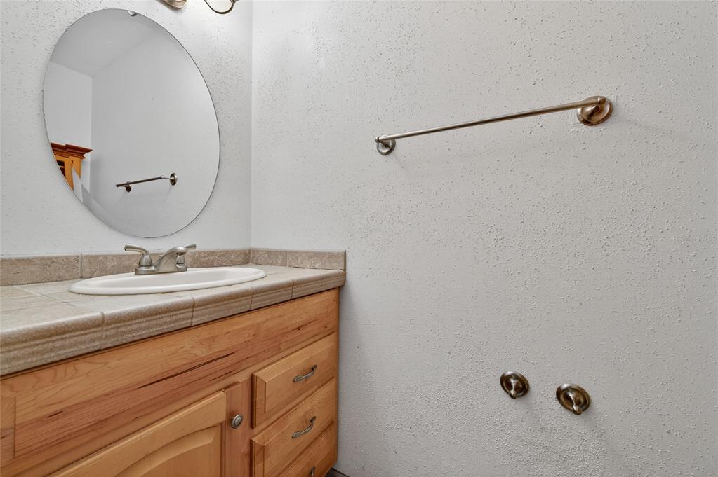 980 Canal View Boulevard, Unit J4 Port Orange, FL 32129 - Photo 5 of 25 a bathroom with a granite countertop sink and a mirror