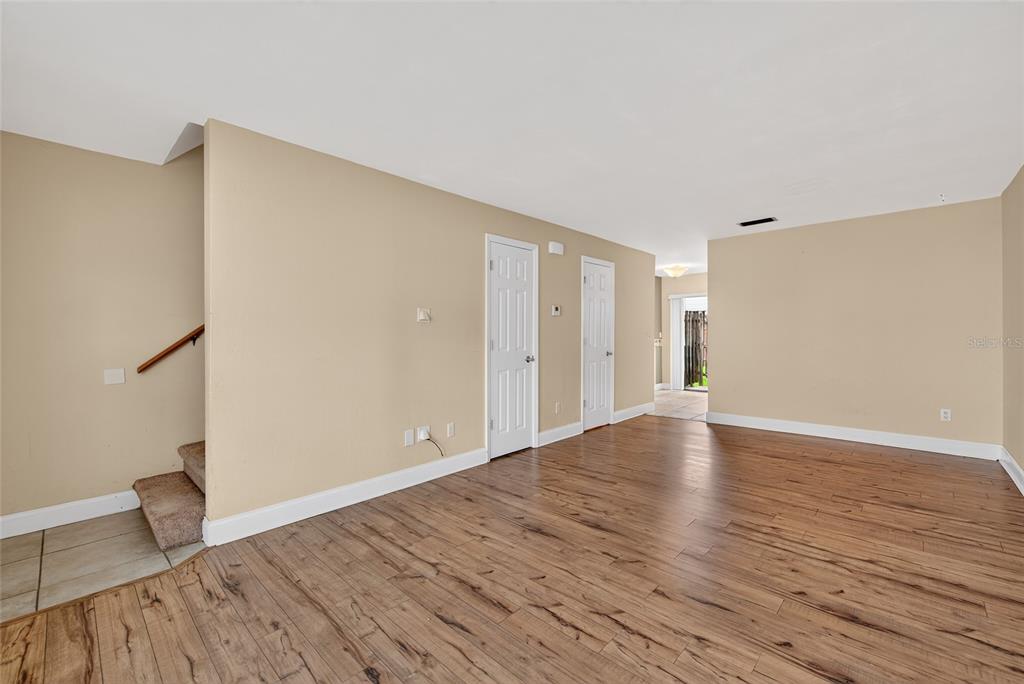 980 Canal View Boulevard, Unit J4 Port Orange, FL 32129 - Photo 7 of 25 a view of an empty room with wooden floor and a window