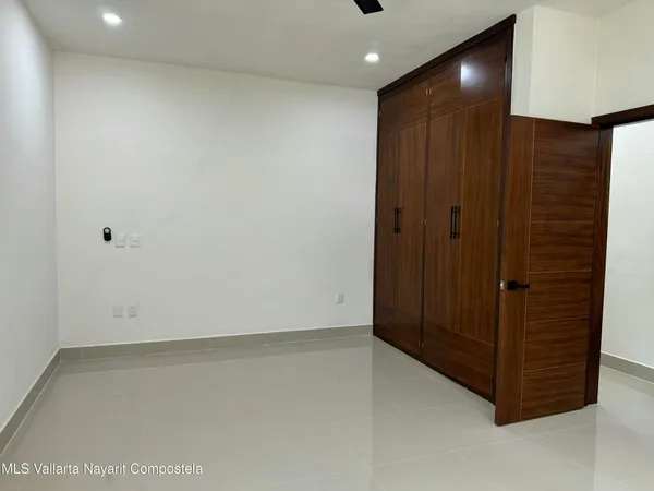 an empty room with closet area