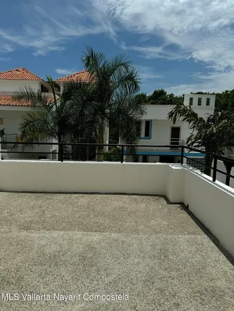 a view of a terrace with a bench and trees