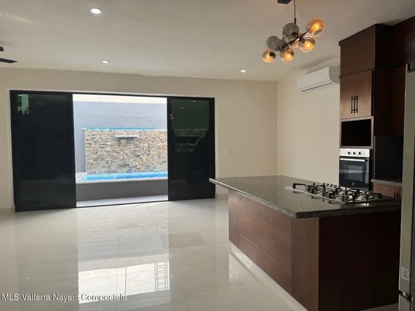 a kitchen with granite countertop a stove and a refrigerator