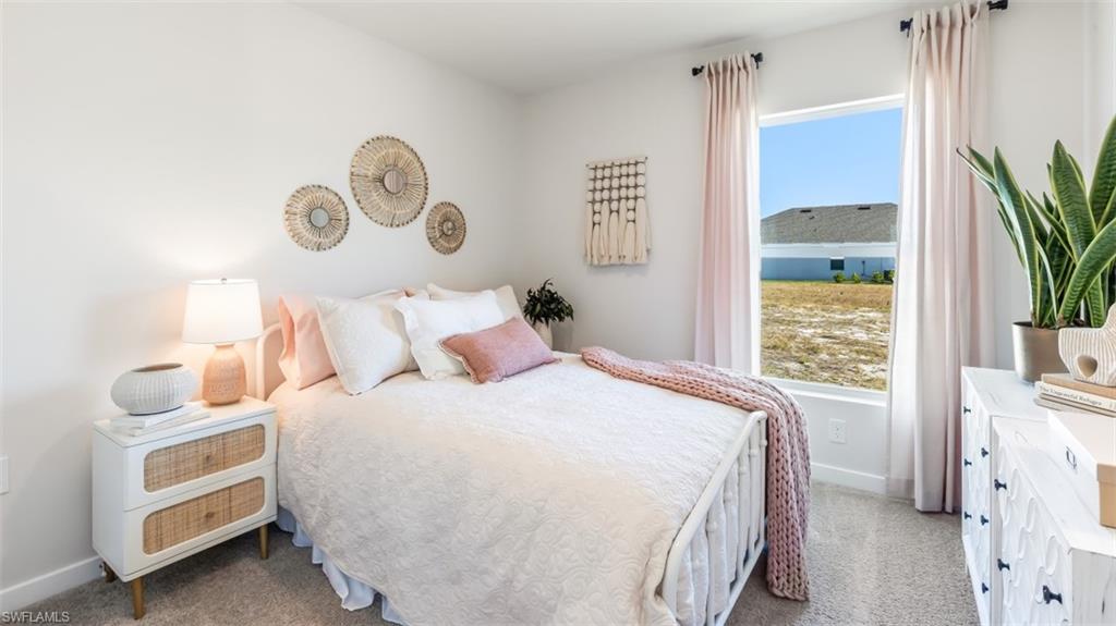 3112 40th Street Southwest Lehigh Acres, FL 33976 - Photo 13 of 15 a bedroom with a bed and a window