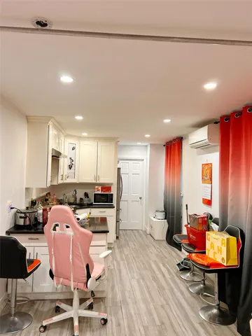 a room with furniture pool table and window