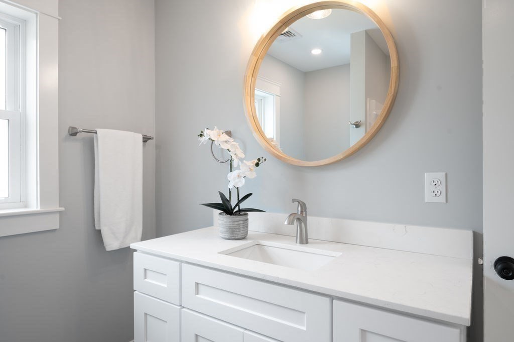 48 Beach Road, Unit C Salisbury, MA 01952 - Photo 32 of 41 a bathroom with a sink and a mirror
