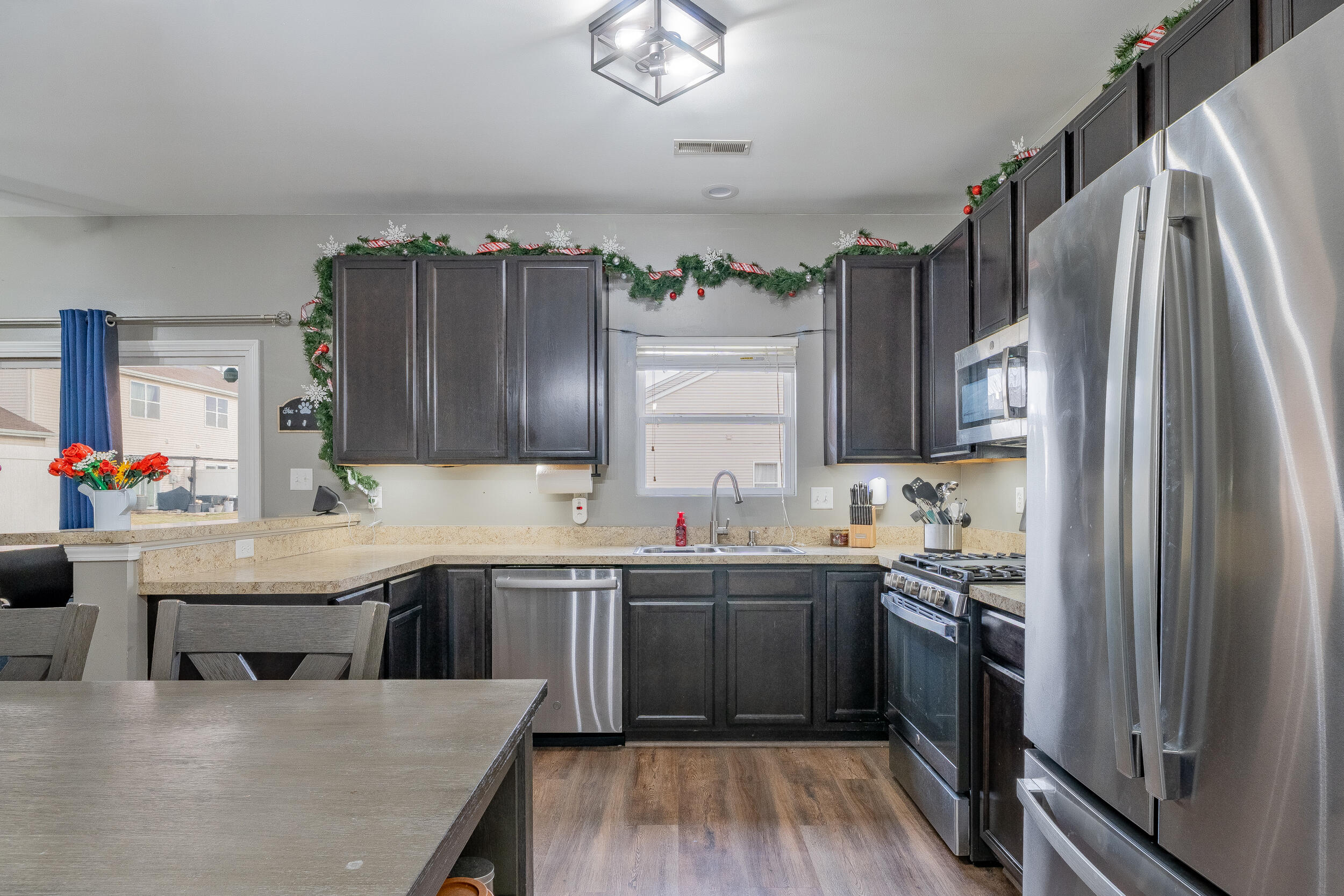 11165 Orange Street Crown Point, IN 46307 - Photo 11 of 33 a kitchen with stainless steel appliances granite countertop a sink stove and refrigerator