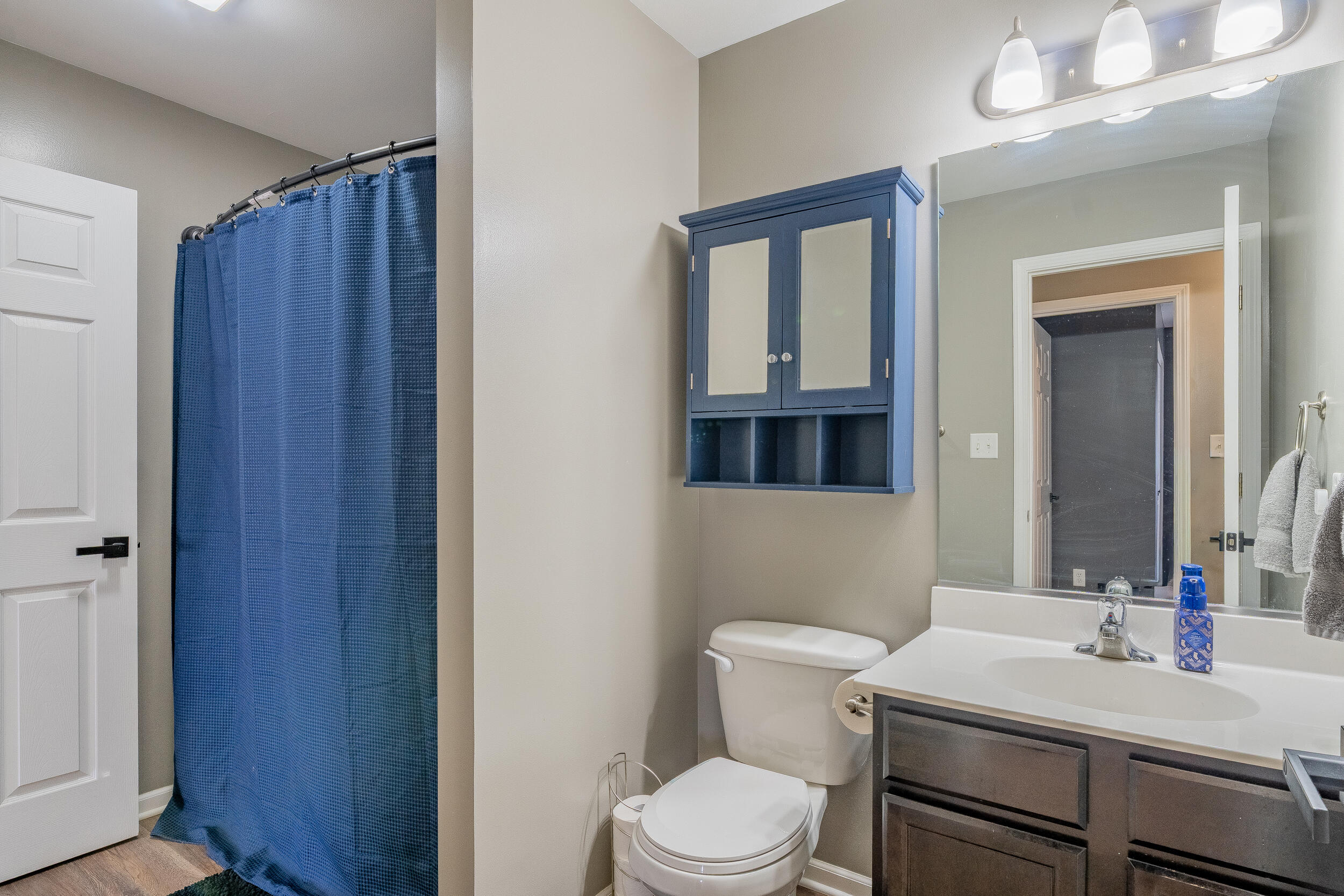 11165 Orange Street Crown Point, IN 46307 - Photo 19 of 33 a bathroom with a toilet a sink and mirror