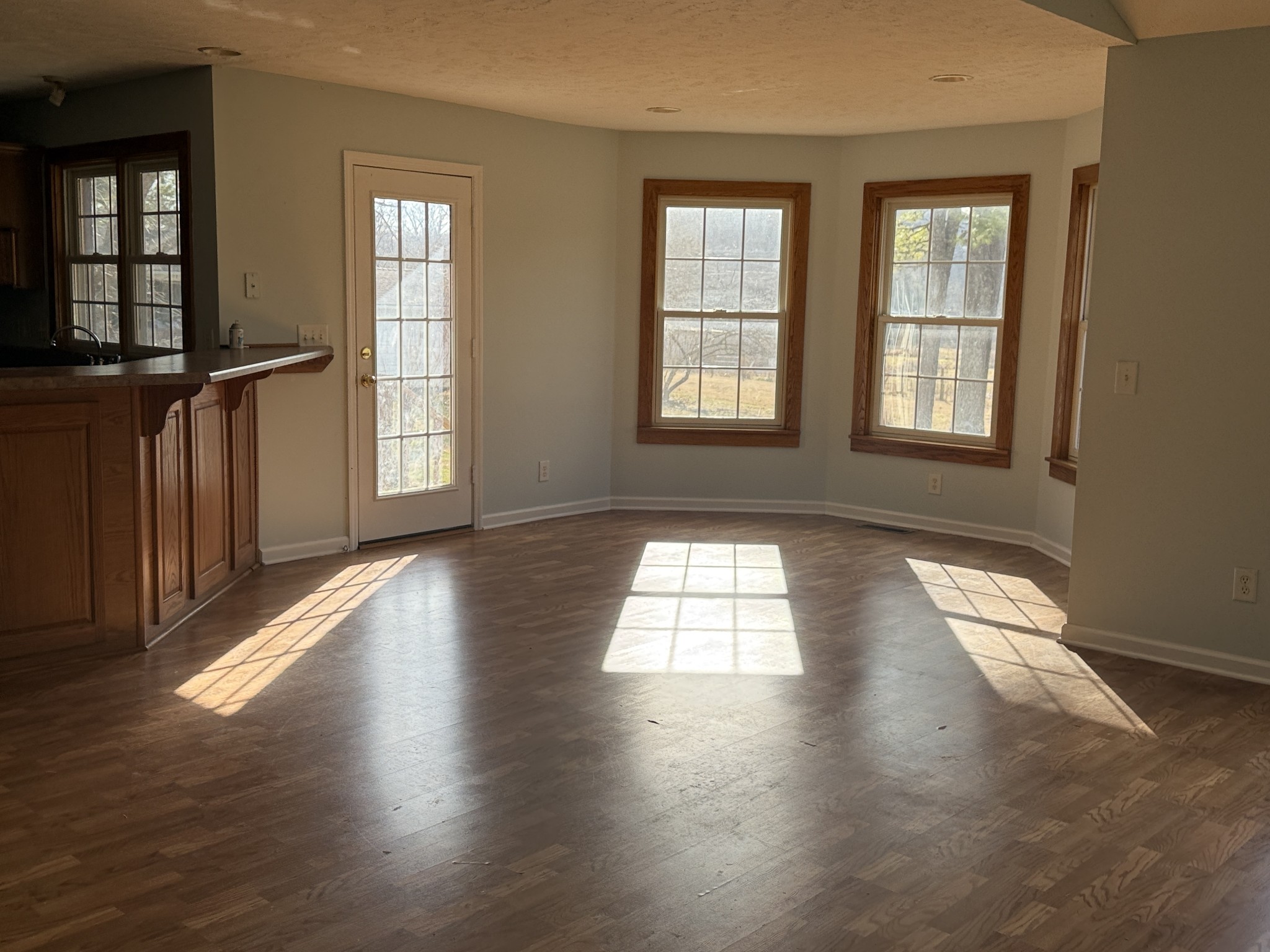 313 Murfreesboro Road Woodbury, TN 37190 - Photo 6 of 8 an empty room with wooden floor and windows