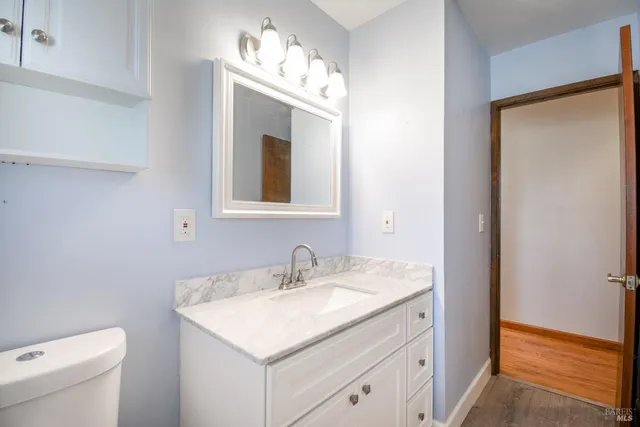 a bathroom with a sink toilet and vanity