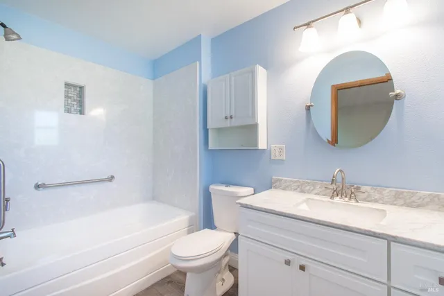 a bathroom with a toilet a sink and bathtub