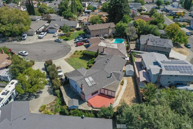 an aerial view of a house with garden space and street view
