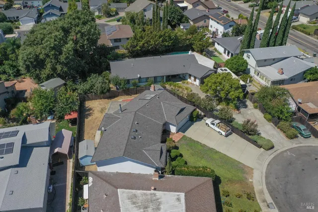an aerial view of multiple houses with yard