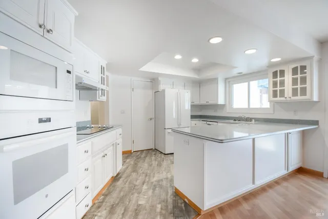a kitchen with stainless steel appliances granite countertop a stove and a sink