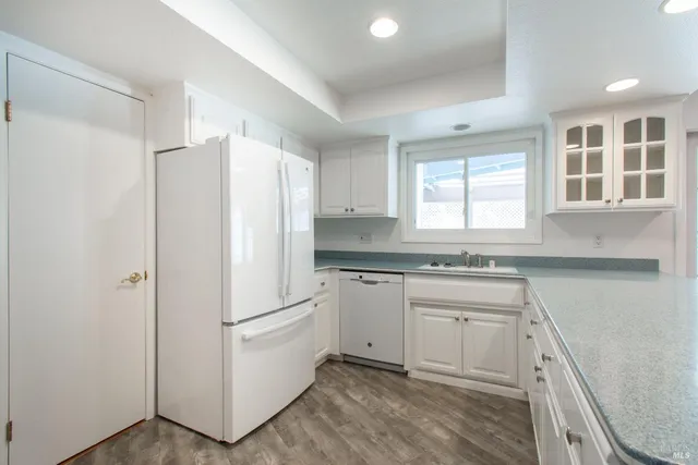 a white refrigerator freezer sitting inside of a kitchen