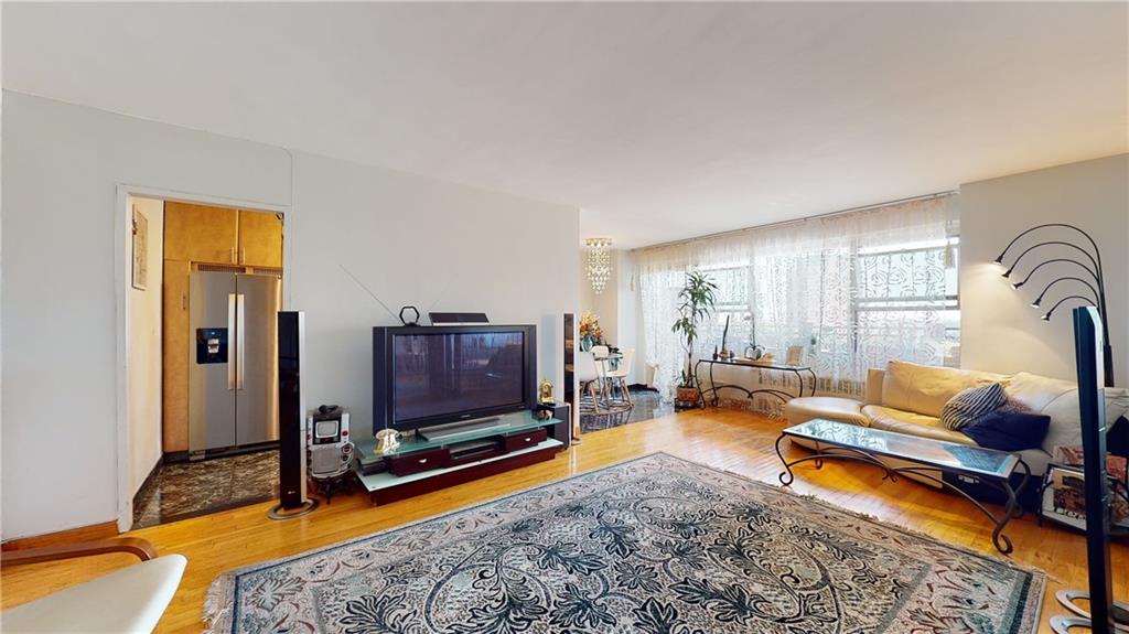 a living room with furniture flat screen tv and a large window
