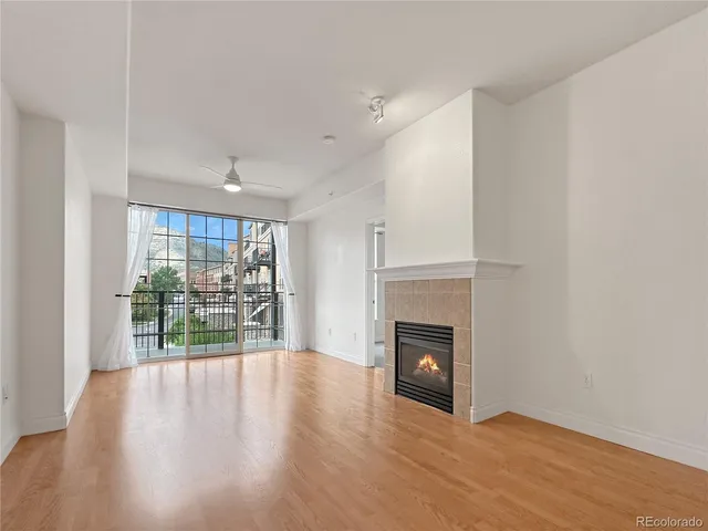 wooden floor in an empty room with a fireplace
