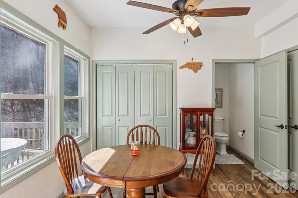 a dining room with furniture a chandelier and window