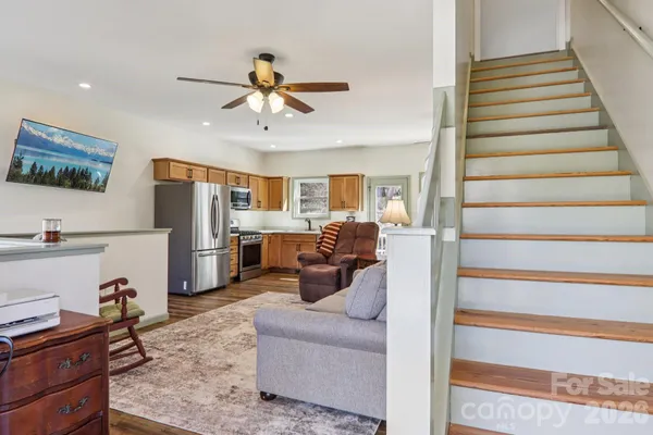 a view of a livingroom with furniture and staircase