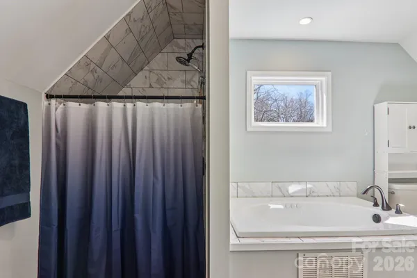 a bathroom with a bathtub and a sink